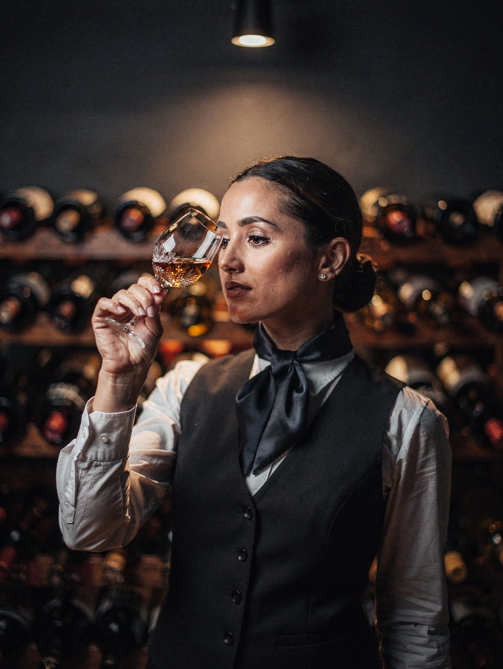 Head Sommelier Elena Ricci selecting a vintage wine from the cellar